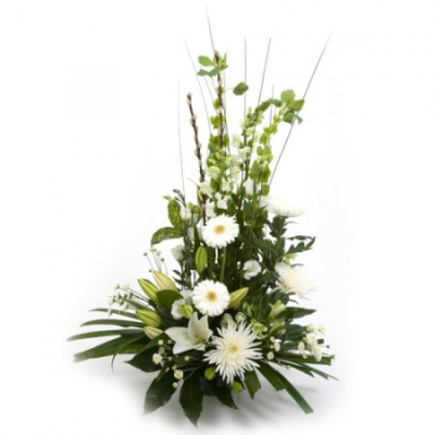 Calm beauty - A gorgeous classical arrangement made in oasis in a front facing style. This charming display is ideal for so many occassions such as anniversaries, birthdays, sympathy flowers to the home, get well soon, sending to nursing homes and the like.

 Perfect for displaying on a fireplace or sidetable, office or reception area. Just add a little water to maintain freshness, no vase required.