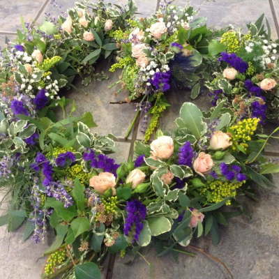 Eco Friendly hand woven funeral wreath - Funeral flowers, Eco friendly, plastic and oasis-free, and kinder to the environment. Our eco caskets sprays and funeral tribute are designed especially for your loved one. They can be made in a variety of colours and include any specially requested flowers that are in season. The main difference is that we use a compostable base, natural moss, and twine in place of the usual plastic tray and oasis foam in their construction. As a result the flowers tend to sit in a looser, more relaxed way, and this technique is ideally suited to a wilder, natural or woodland vibe, rather than a very uniform formal arrangement.

Our eco Heart is handmade by the florist in dogwood and the flowers and foliage are bound onto the Heart  using twine for a beautiful natural effect.

This technique takes a little longer and is not available for same or next day delivery, 
Best suited to a wild, woodland vibe as flowers are chosen with care for their long lasting qualities.  Size approximately. 17" wide